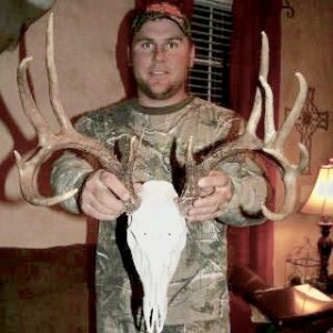 Brad Jones holding a deer skull. Brad is an avid hunter in Texas.